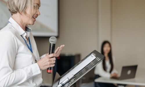 blond woman giving a presentation