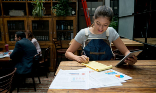 Woman business owner writing a business plan